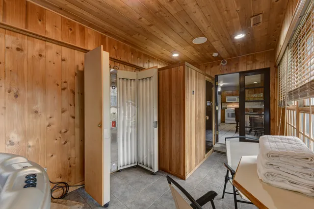 a view of a hallway with workspace and a window