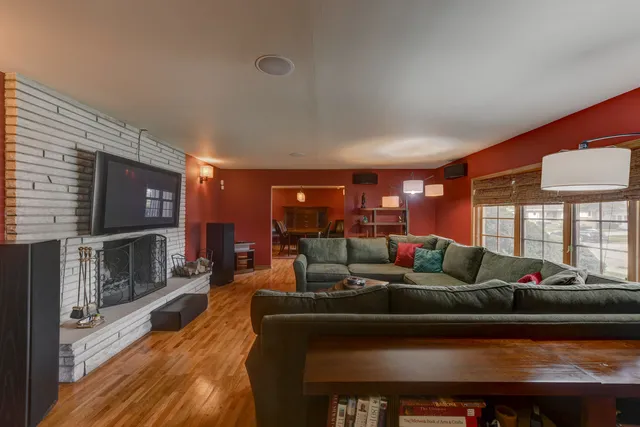 a living room with fireplace furniture and a flat screen tv