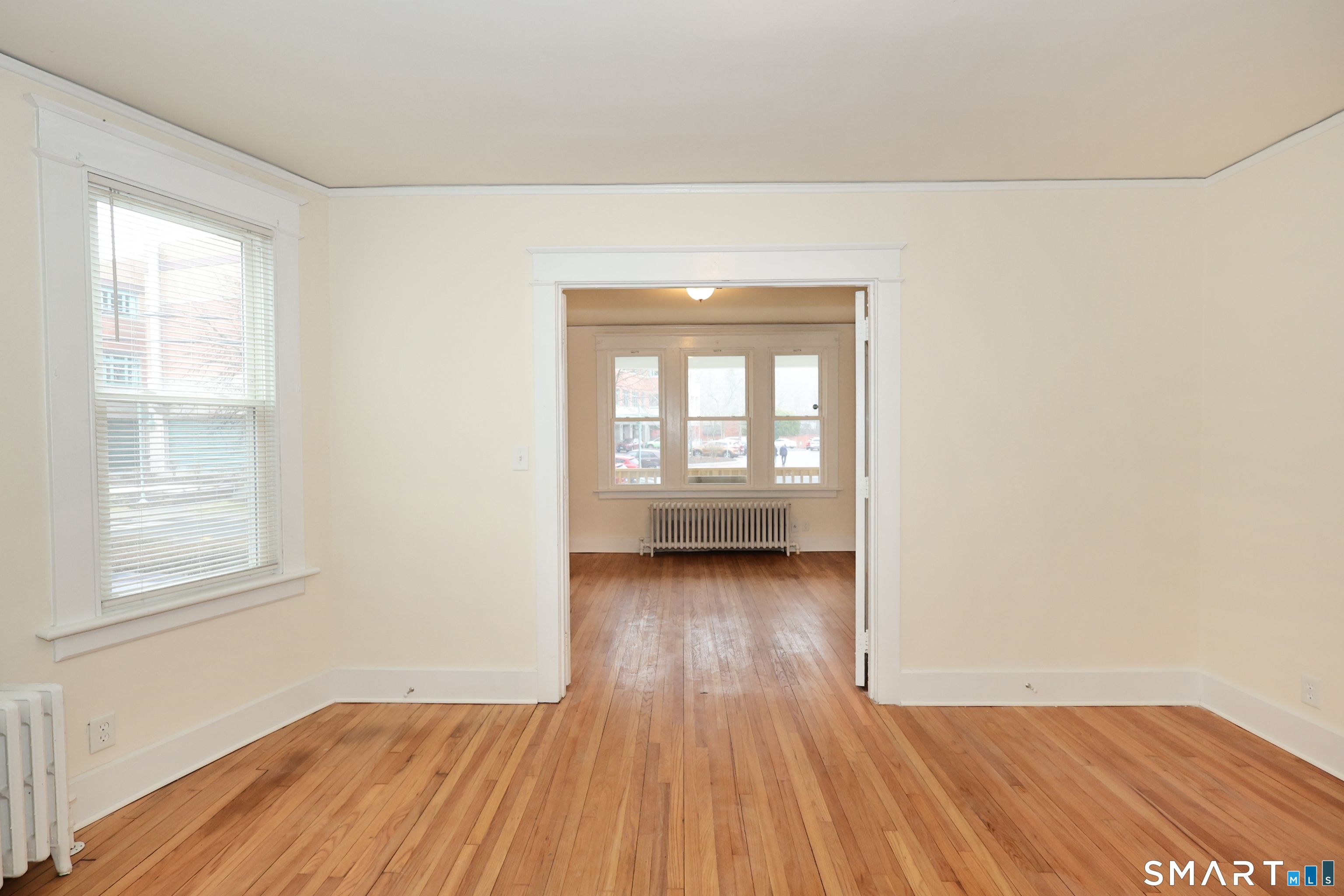 146 Division Street, Unit 1 Ansonia, CT 06401 - Photo 14 of 27 an empty room with wooden floor and windows