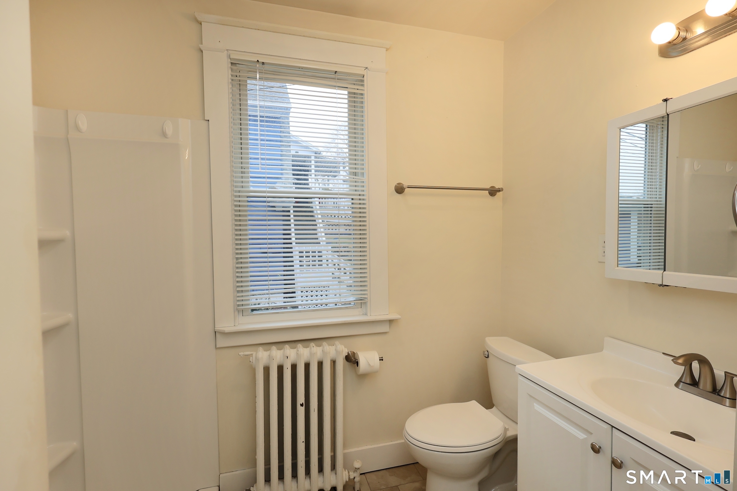 146 Division Street, Unit 1 Ansonia, CT 06401 - Photo 19 of 27 a bathroom with a sink a toilet and a mirror
