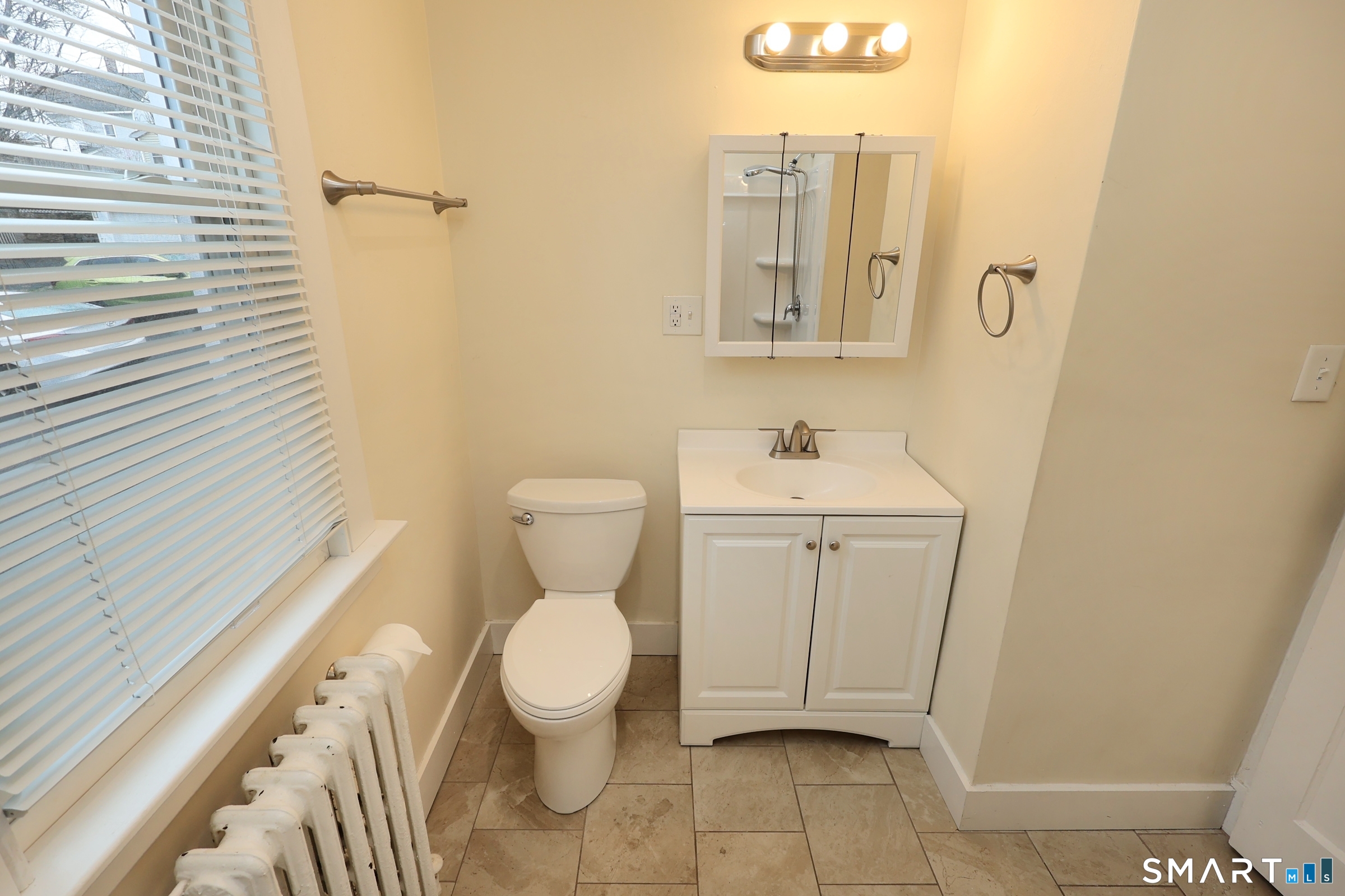 146 Division Street, Unit 1 Ansonia, CT 06401 - Photo 20 of 27 a bathroom with a sink toilet and shower
