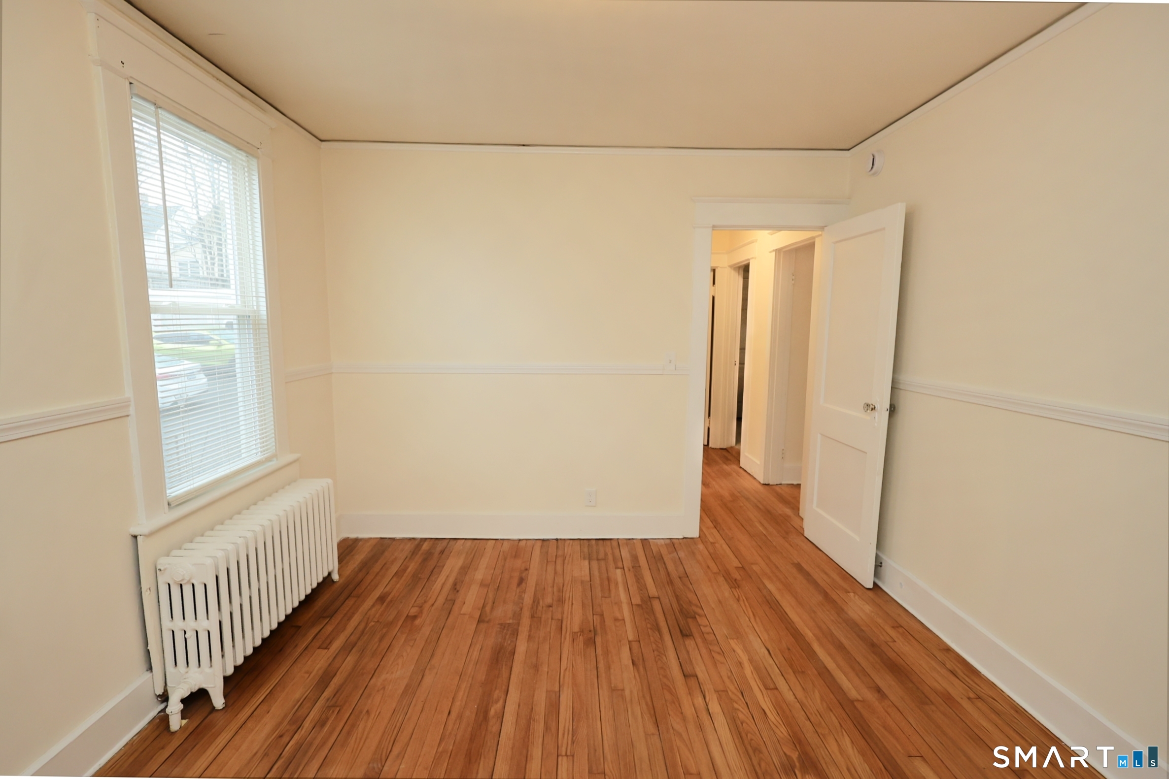 146 Division Street, Unit 1 Ansonia, CT 06401 - Photo 22 of 27 a view of a room with wooden floor and a window