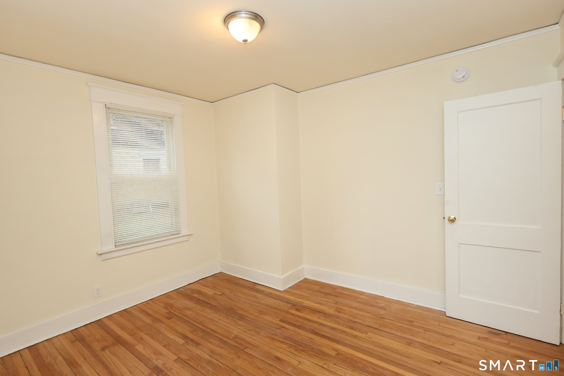 146 Division Street, Unit 1 Ansonia, CT 06401 - Photo 25 of 27 a view of empty room with wooden floor and fan