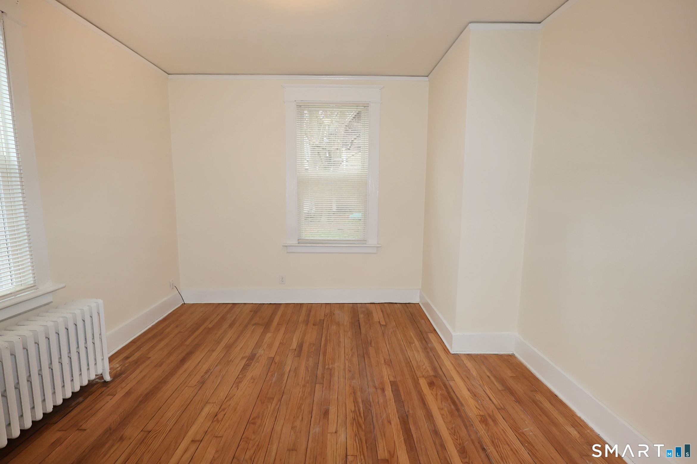 146 Division Street, Unit 1 Ansonia, CT 06401 - Photo 26 of 27 a view of an empty room with wooden floor and a window