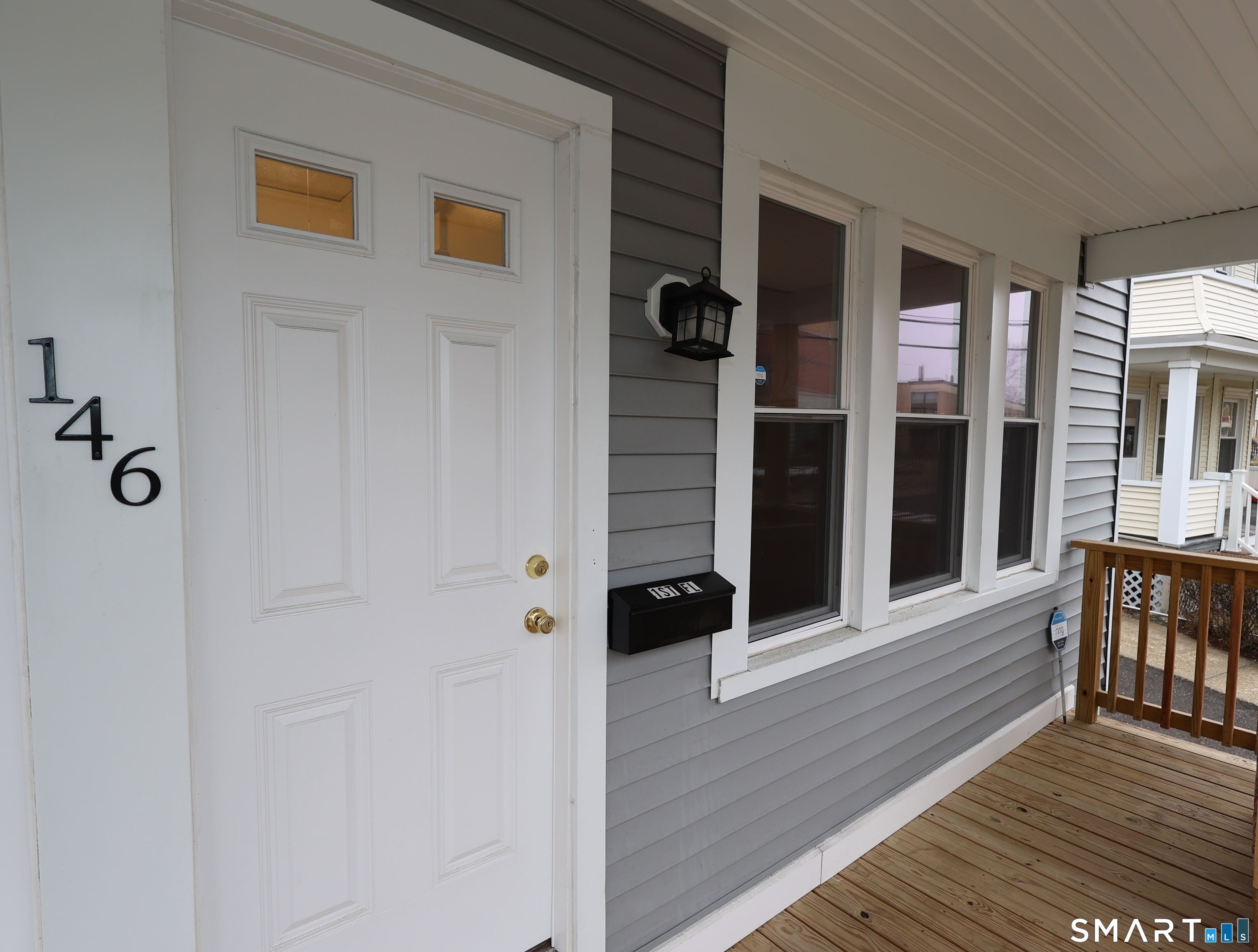 146 Division Street, Unit 1 Ansonia, CT 06401 - Photo 3 of 27 a view of a balcony with furniture and wooden floor