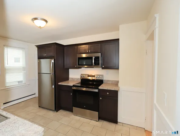 a kitchen with a refrigerator and a stove