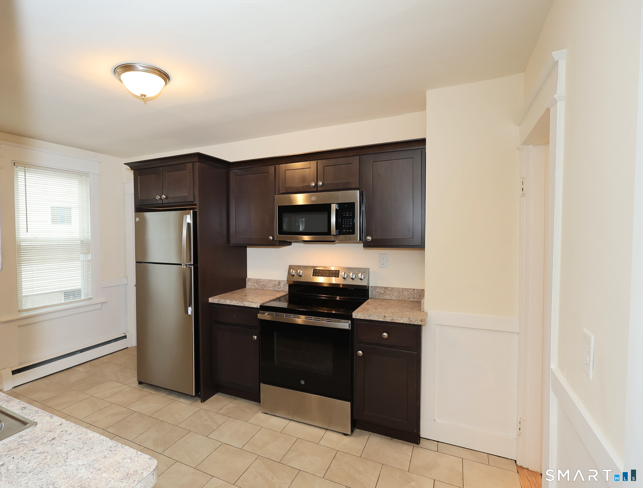 146 Division Street, Unit 1 Ansonia, CT 06401 - Photo 5 of 27 a kitchen with a refrigerator and a stove