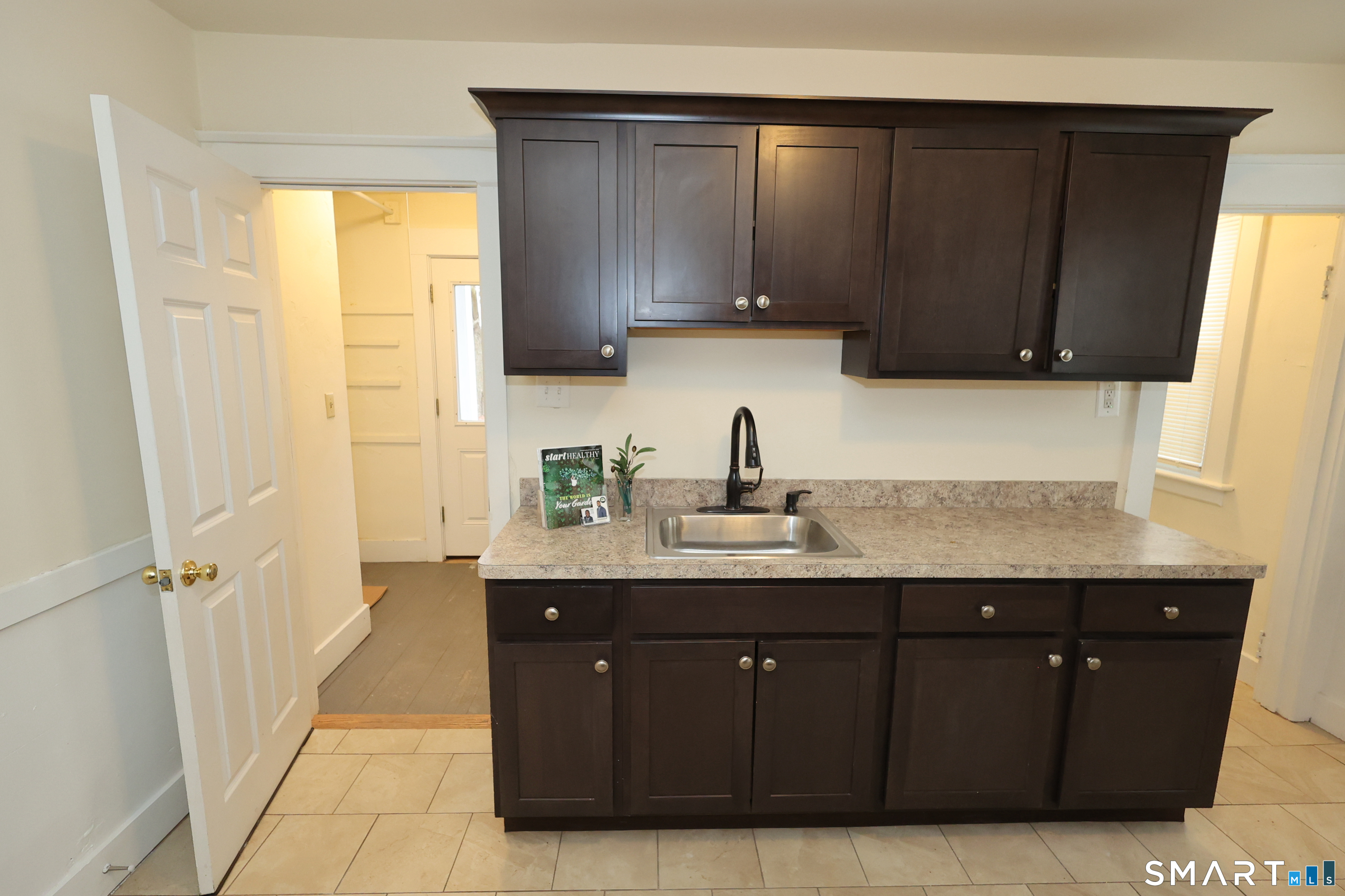 146 Division Street, Unit 1 Ansonia, CT 06401 - Photo 6 of 27 a kitchen with a sink a window and cabinets