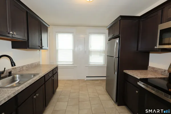 a kitchen with a sink stove and refrigerator
