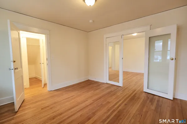 wooden floor in an empty room with a window