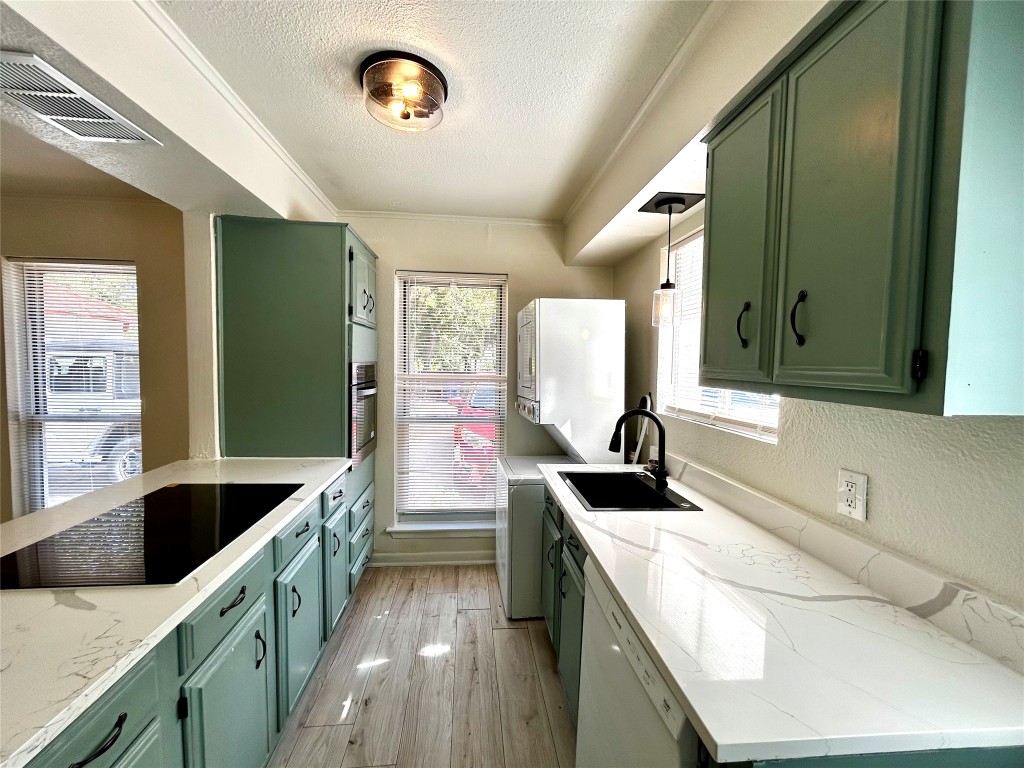 1005 West Martin Luther King Jr Boulevard, Unit B Austin, TX 78701 - Photo 11 of 29 a bathroom with a sink and a large mirror