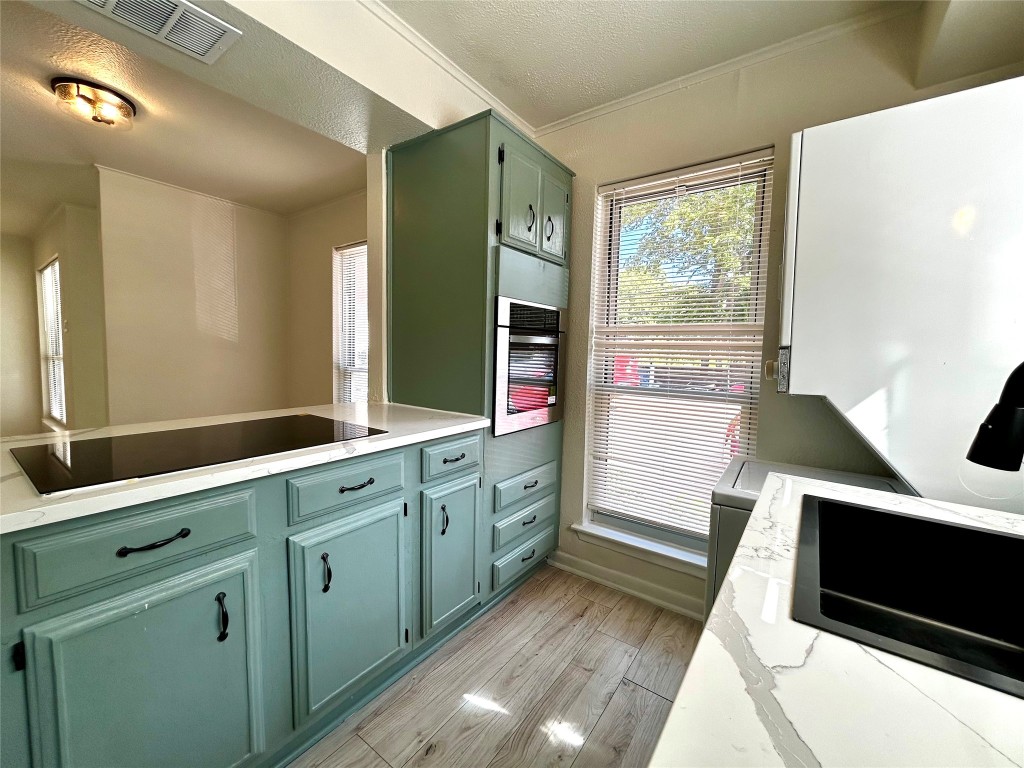 1005 West Martin Luther King Jr Boulevard, Unit B Austin, TX 78701 - Photo 13 of 29 a kitchen with sink and cabinets