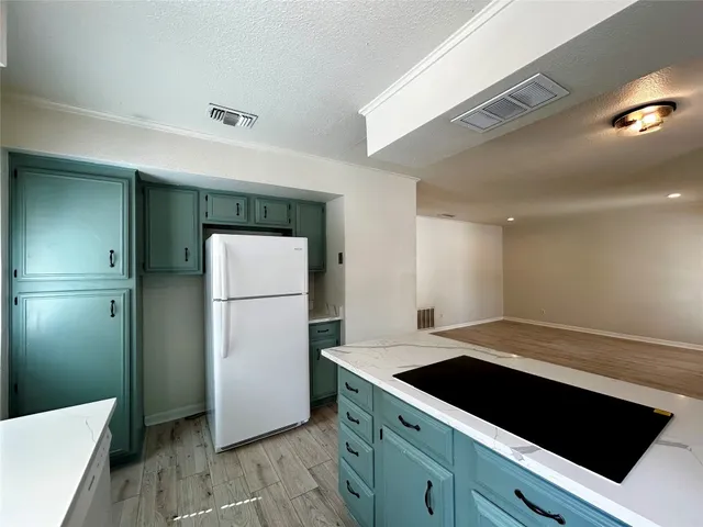 a kitchen with a refrigerator and a sink