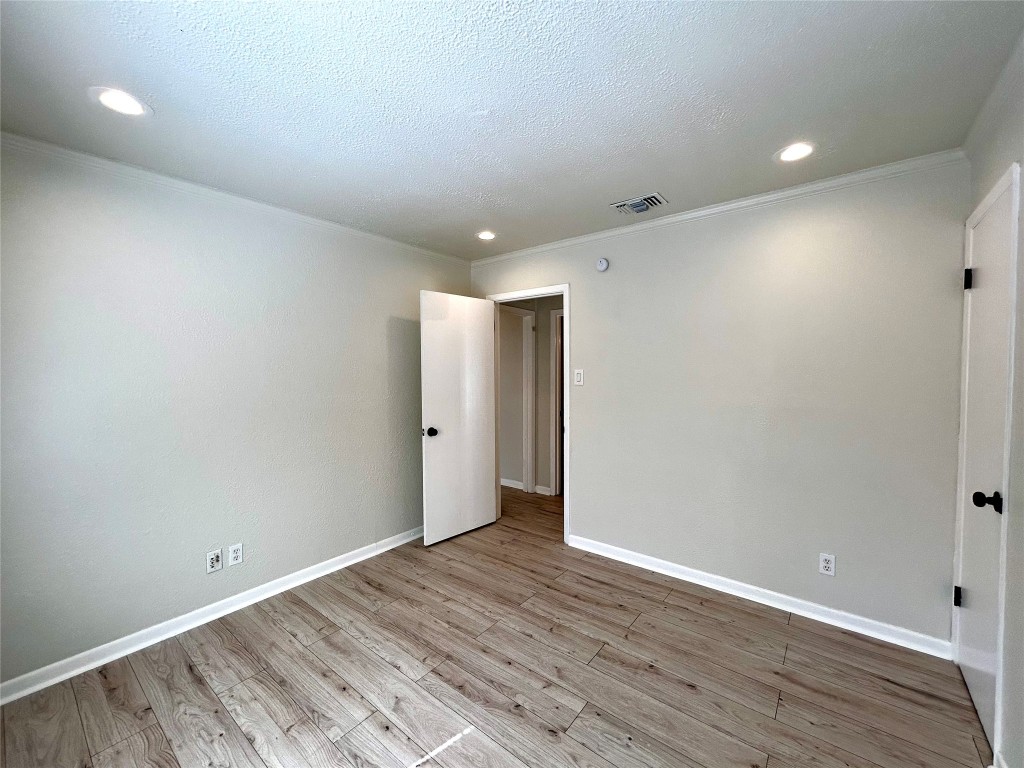 1005 West Martin Luther King Jr Boulevard, Unit B Austin, TX 78701 - Photo 18 of 29 a view of an empty room with wooden floor