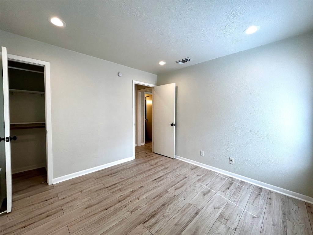 1005 West Martin Luther King Jr Boulevard, Unit B Austin, TX 78701 - Photo 23 of 29 a view of an empty room with wooden floor