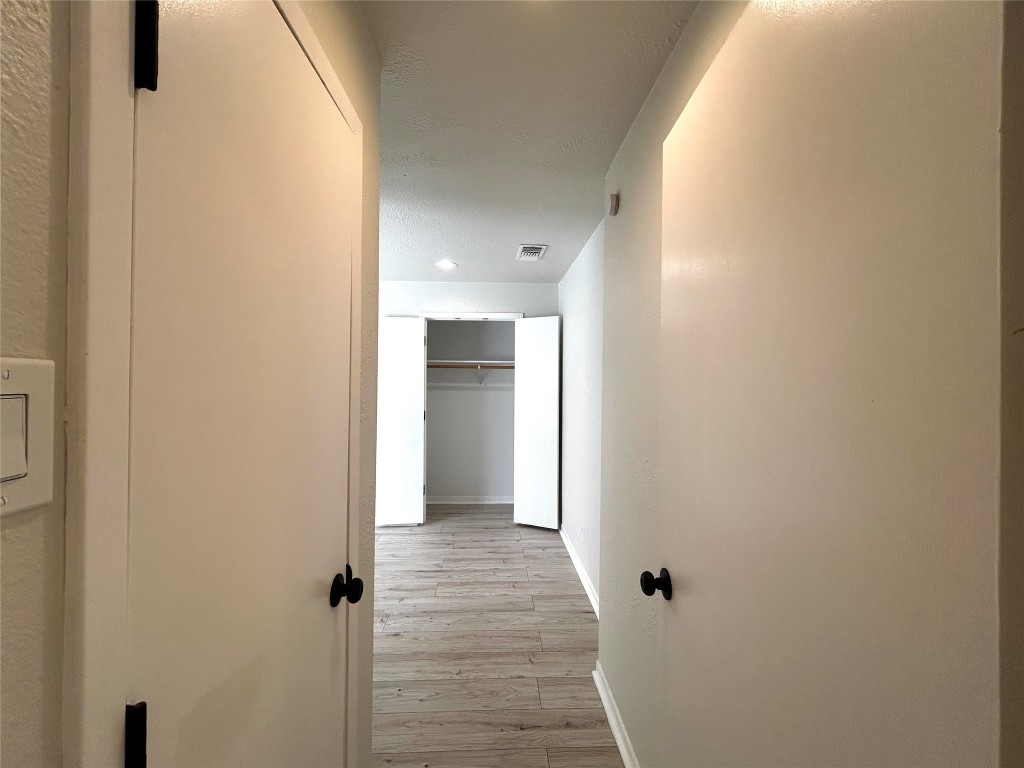1005 West Martin Luther King Jr Boulevard, Unit B Austin, TX 78701 - Photo 24 of 29 a view of a hallway with wooden floor and closet