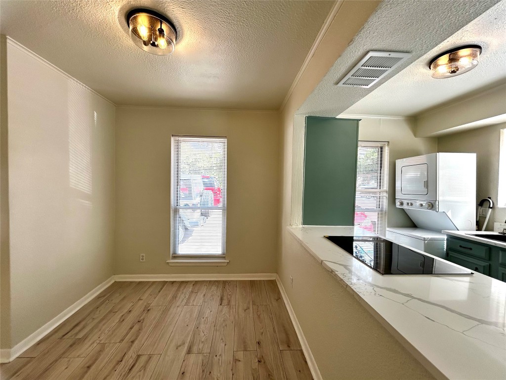 1005 West Martin Luther King Jr Boulevard, Unit B Austin, TX 78701 - Photo 6 of 29 a kitchen with a wooden floor and a large window