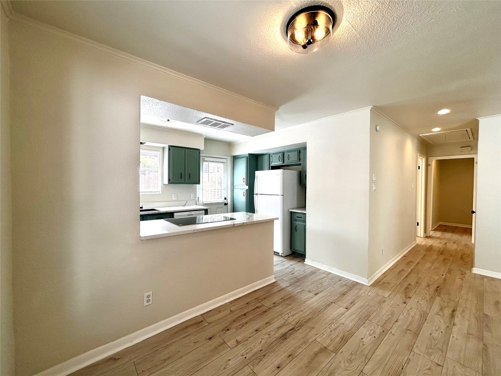 1005 West Martin Luther King Jr Boulevard, Unit B Austin, TX 78701 - Photo 7 of 29 a view of kitchen with stainless steel appliances granite countertop cabinets and wooden floor