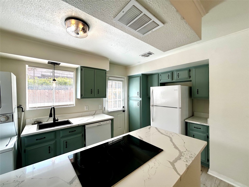 1005 West Martin Luther King Jr Boulevard, Unit B Austin, TX 78701 - Photo 9 of 29 a kitchen with a refrigerator and a sink