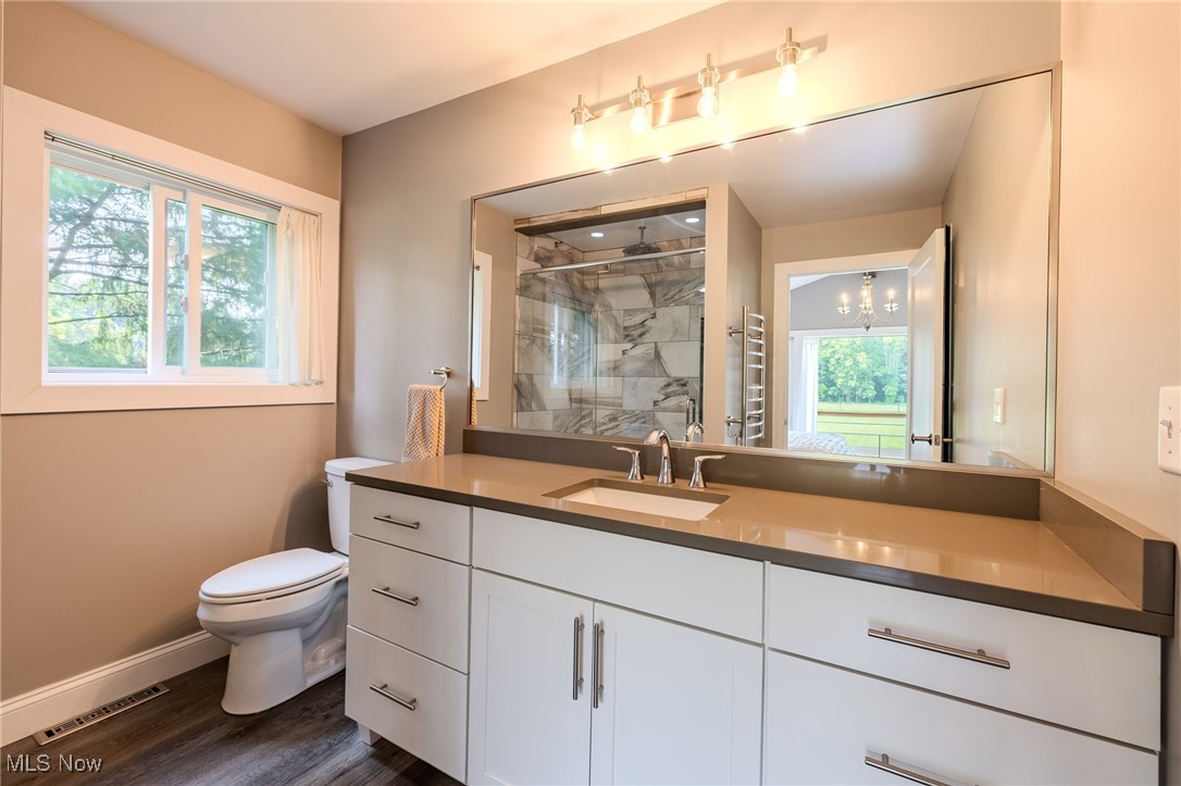 6268 Summers Road Windsor, OH 44099 - Photo 36 of 49 Full bath with toilet, a marble finish shower, vanity, baseboards, and wood finished floors