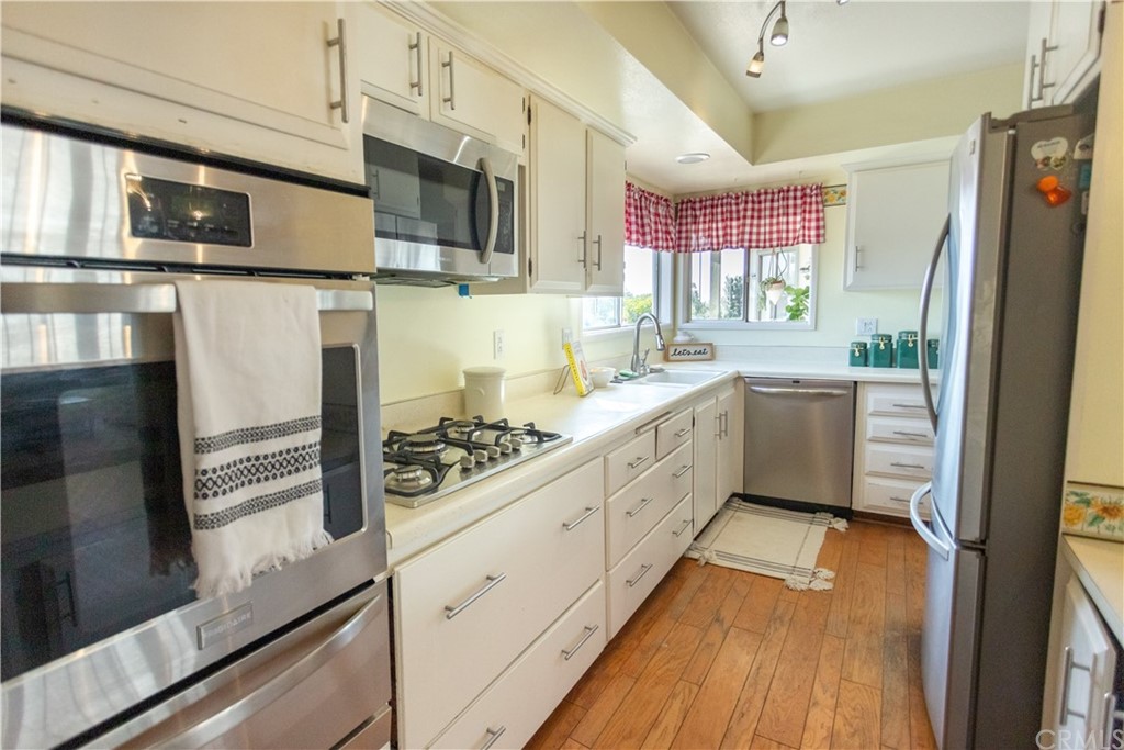 395 Pineridge Street Brea, CA 92821 - Photo 18 of 39 a kitchen with stainless steel appliances granite countertop a sink a stove and a refrigerator