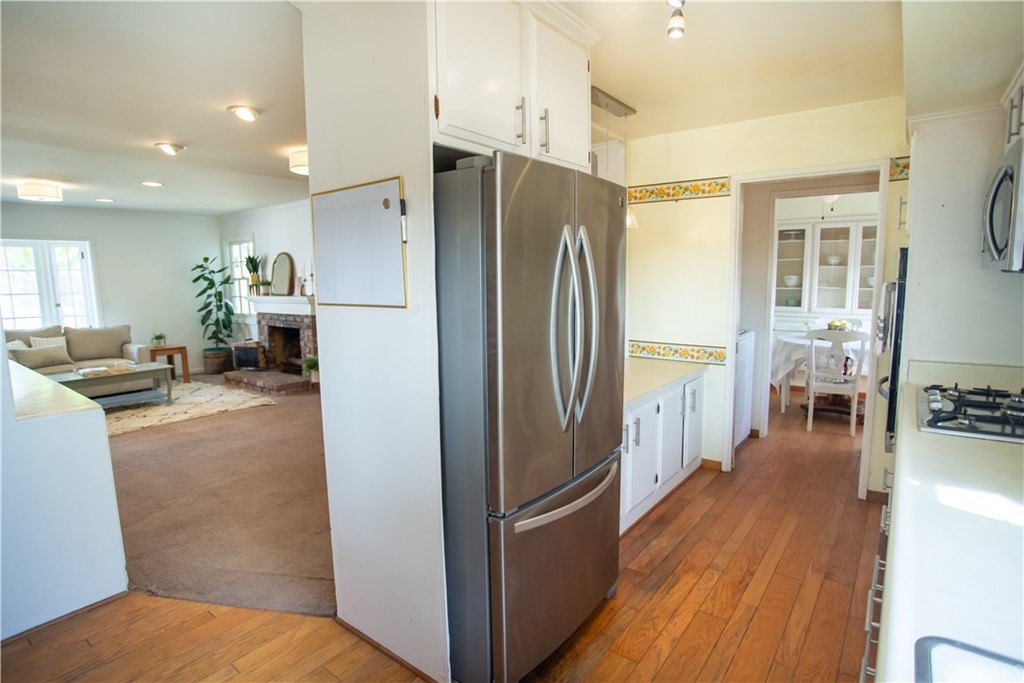 395 Pineridge Street Brea, CA 92821 - Photo 21 of 39 a kitchen with stainless steel appliances a refrigerator and wooden floor