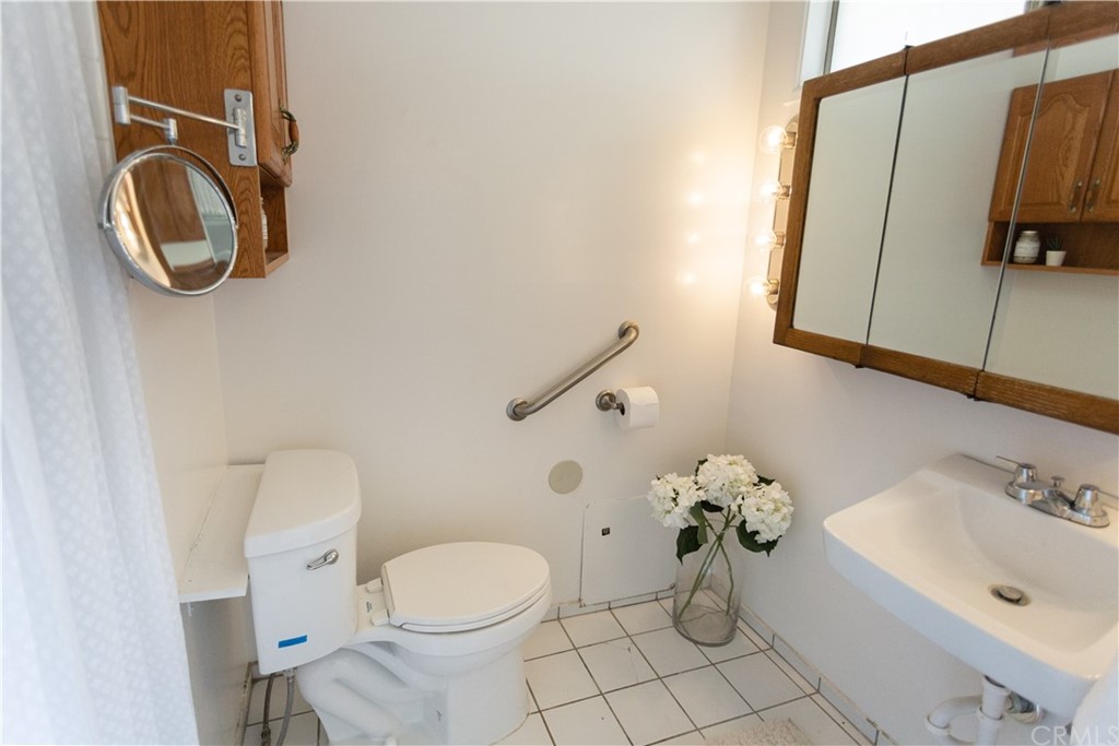 395 Pineridge Street Brea, CA 92821 - Photo 34 of 39 a bathroom with a toilet sink and mirror