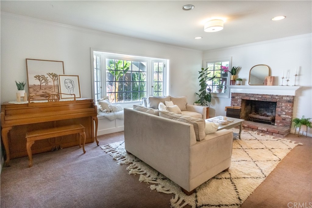 395 Pineridge Street Brea, CA 92821 - Photo 10 of 39 a living room with furniture a fireplace and a large window