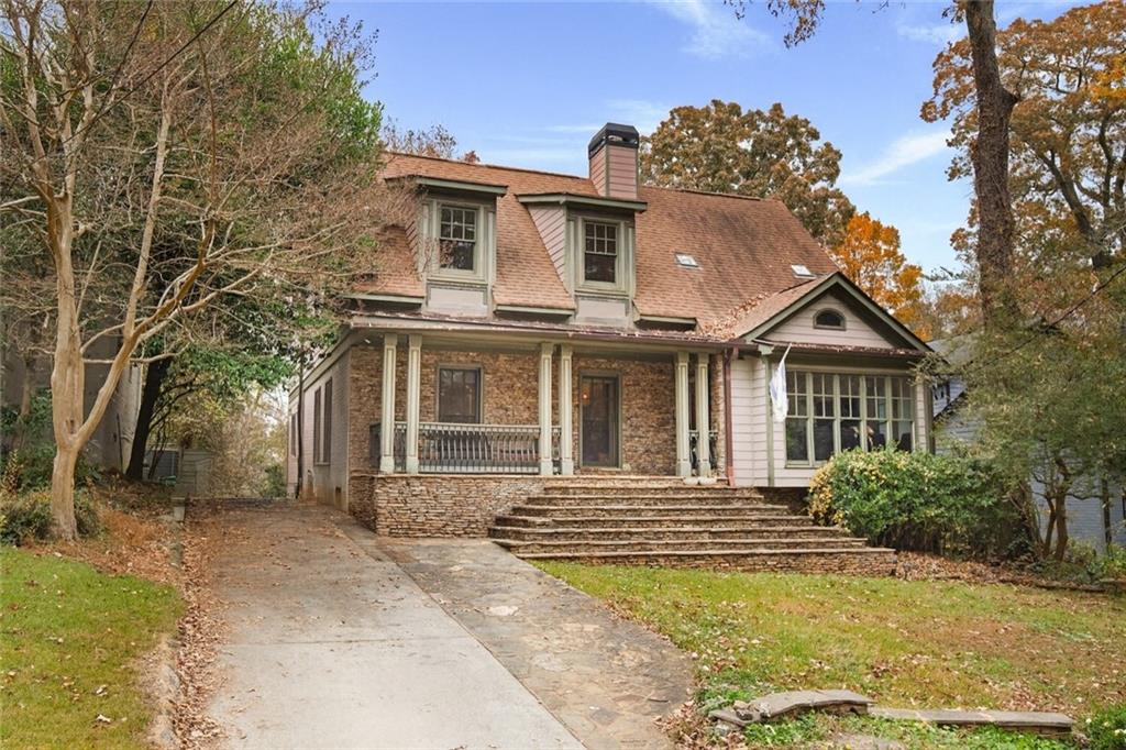 451 Hascall Road Northwest Atlanta, GA 30309 - Photo 1 of 26 a front view of a house with a yard
