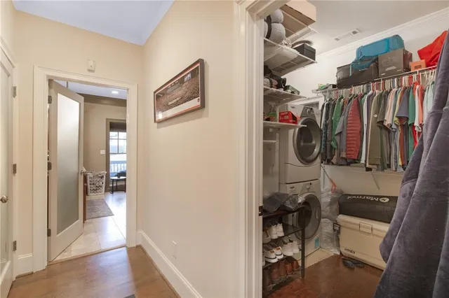 a view of walk in closet with clothes and shoes