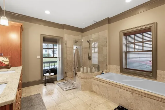 a spacious bathroom with a tub shower and toilet