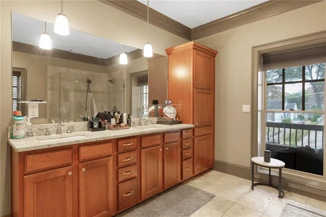a spacious bathroom with a double vanity sink and a mirror