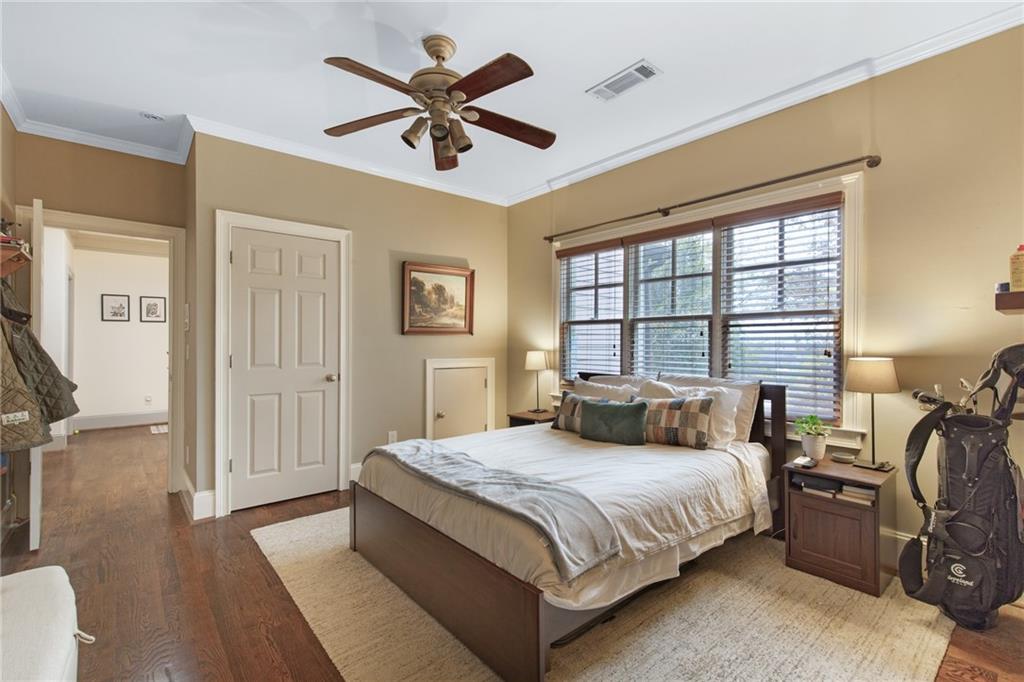 451 Hascall Road Northwest Atlanta, GA 30309 - Photo 21 of 26 a bedroom with a bed and a chandelier