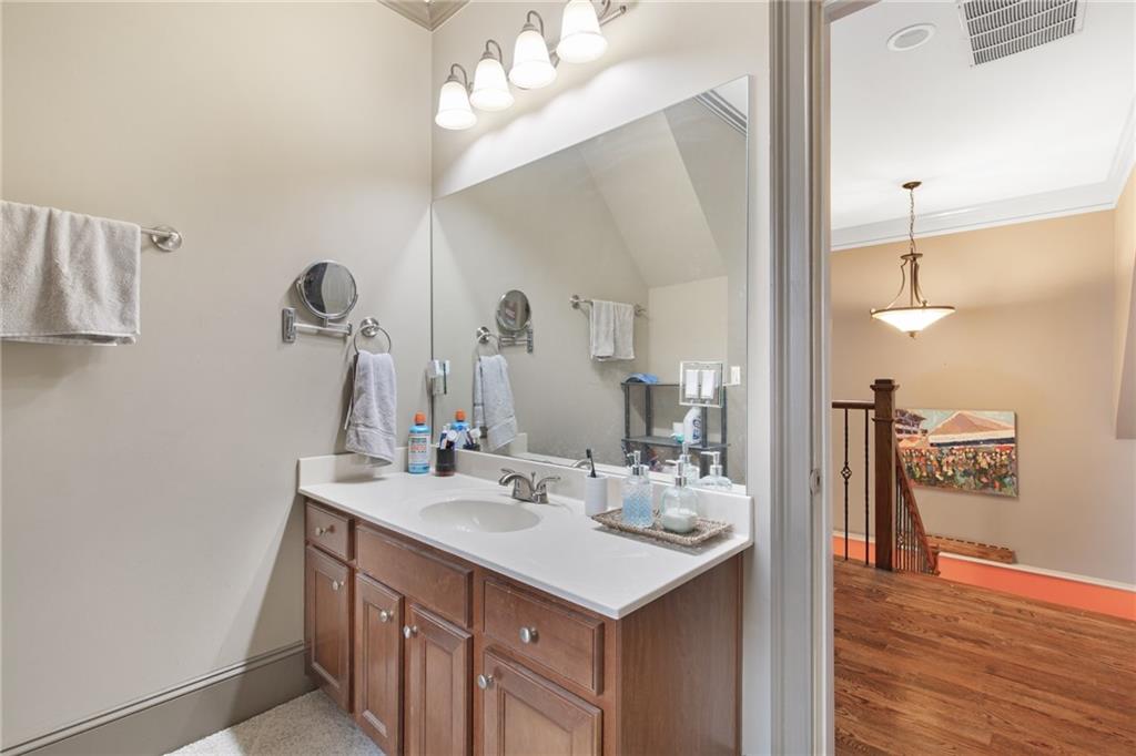 451 Hascall Road Northwest Atlanta, GA 30309 - Photo 22 of 26 a bathroom with a sink a mirror and a shower