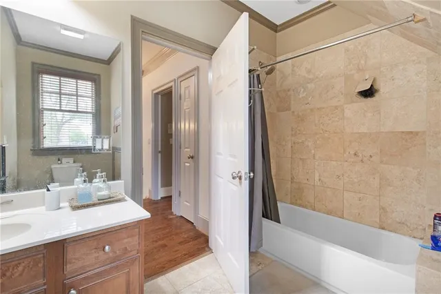 a bathroom with a granite countertop sink a mirror and a bathtub