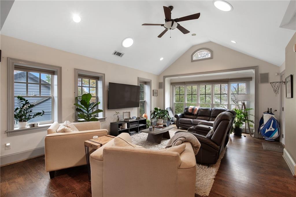 451 Hascall Road Northwest Atlanta, GA 30309 - Photo 6 of 26 a living room with furniture a ceiling fan a flat screen tv and a large window