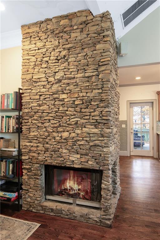 451 Hascall Road Northwest Atlanta, GA 30309 - Photo 7 of 26 a room with a wooden floor and a fireplace