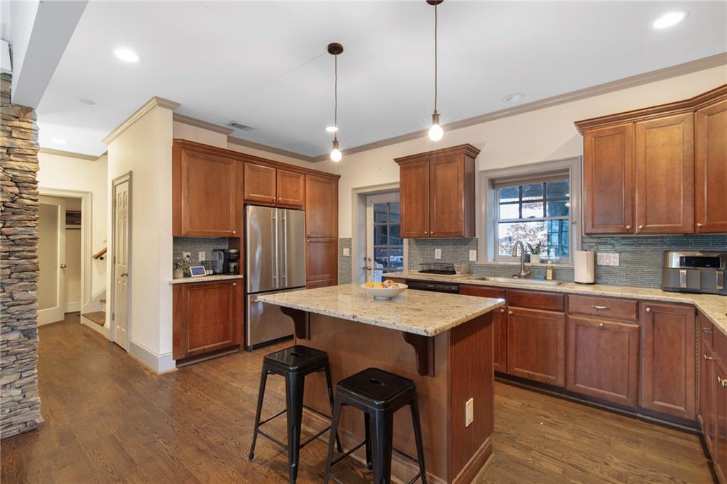 451 Hascall Road Northwest Atlanta, GA 30309 - Photo 9 of 26 a kitchen with stainless steel appliances granite countertop a refrigerator a sink dishwasher a stove and white cabinets with wooden floor