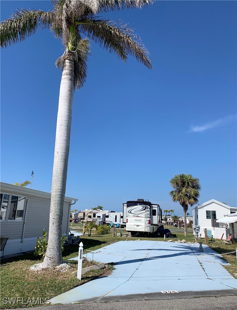 19681 Summerlin Road, Unit 225J Fort Myers, FL 33908 - Photo 4 of 6 a car parked on the side of the road