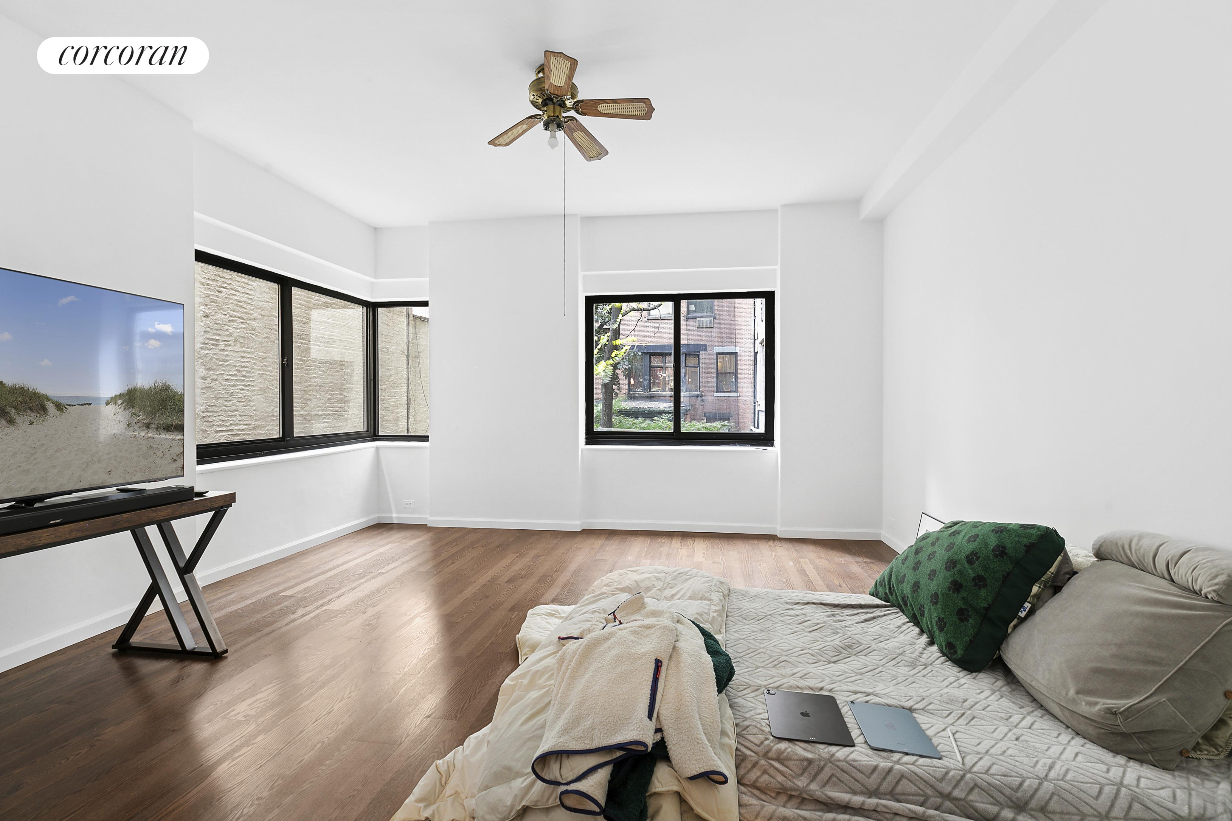 25 East 83rd Street, Unit 2E Manhattan, NY 10028 - Photo 16 of 19 a living room with furniture