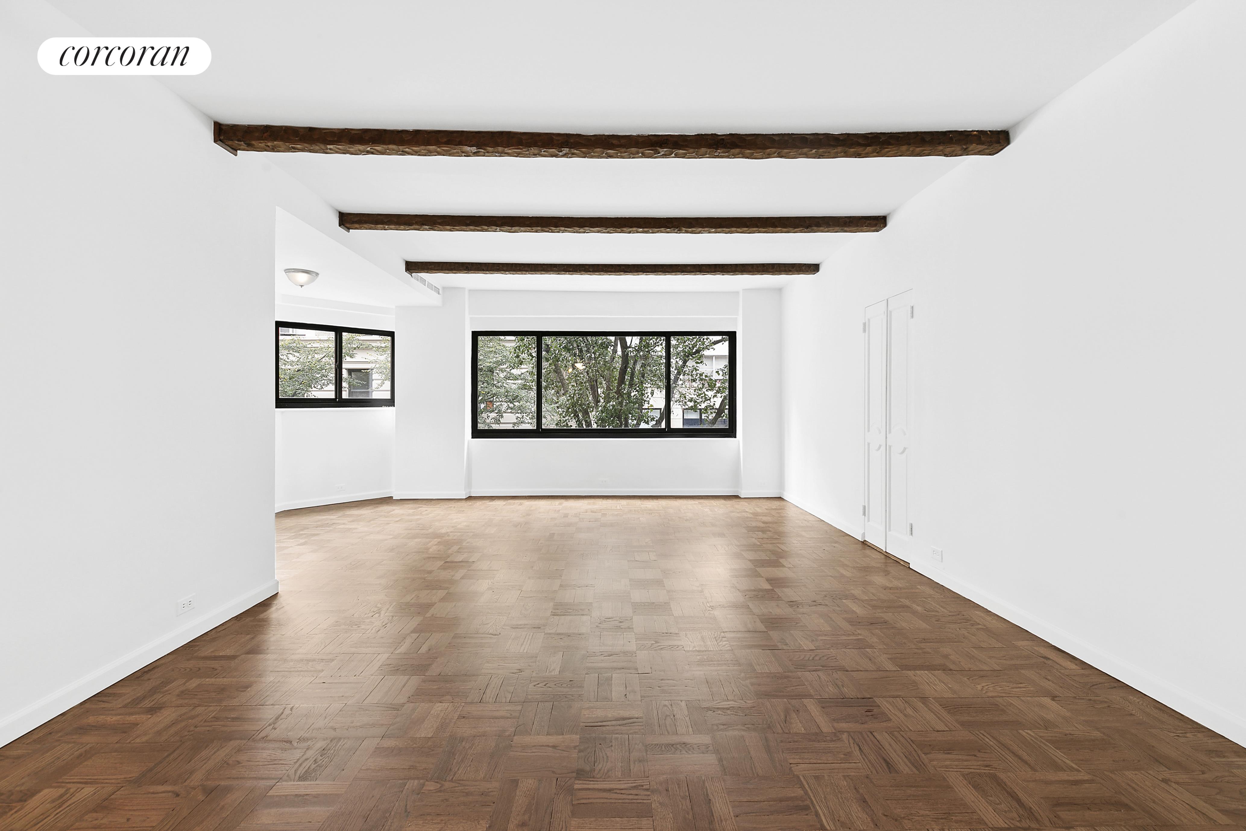 25 East 83rd Street, Unit 2E Manhattan, NY 10028 - Photo 8 of 19 a view of an empty room with wooden floor and a window