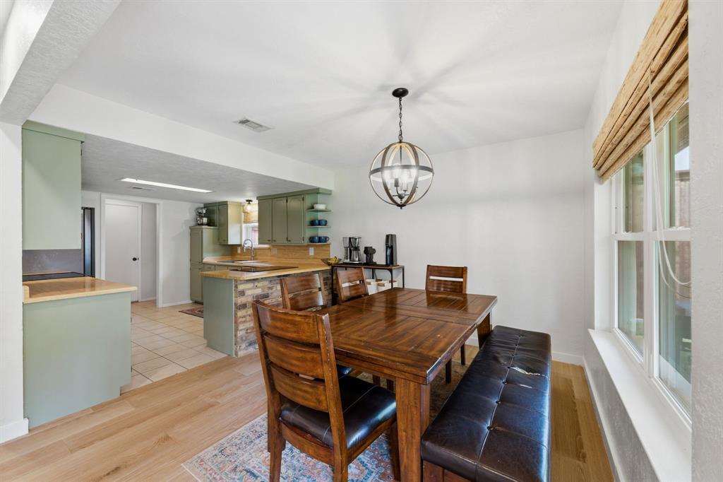 224 Overcrest Drive Benbrook, TX 76126 - Photo 11 of 39 a view of a dining room with furniture window and wooden floor