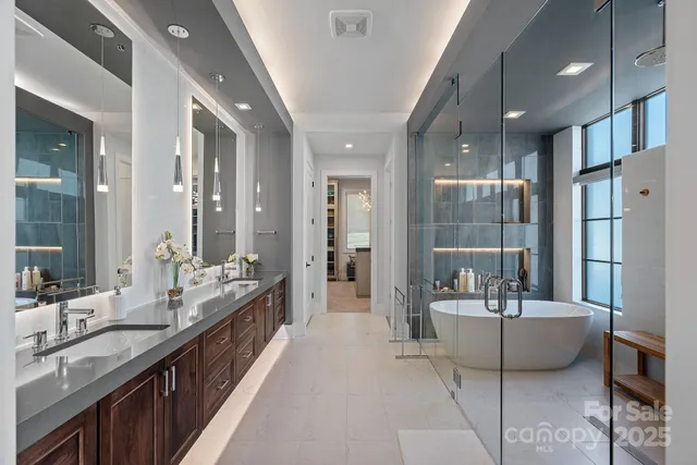 a living room with furniture a chandelier and a flat screen tv