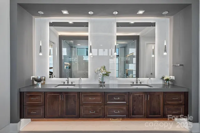 a living room with furniture a chandelier and a flat screen tv