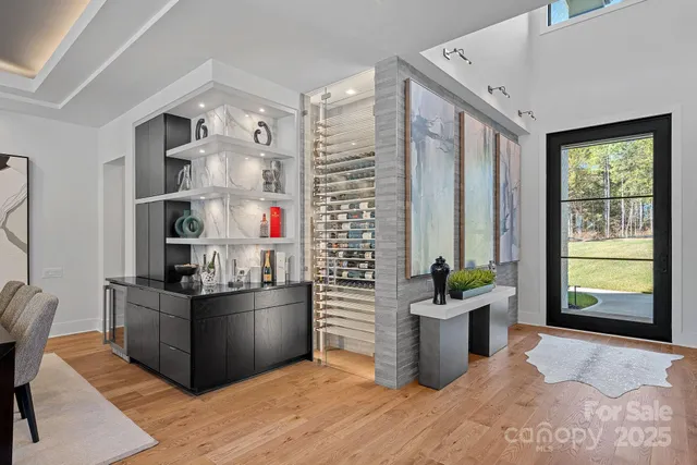 a kitchen with granite countertop a table chairs stove a refrigerator and chandelier