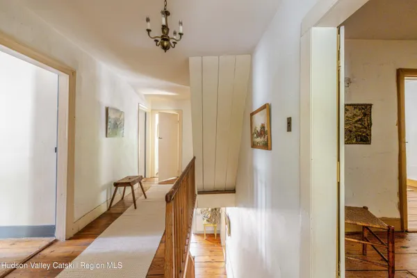 a view of a hallway with furniture and front door