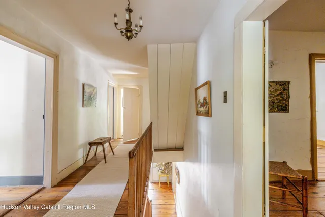 a view of a hallway with furniture and front door