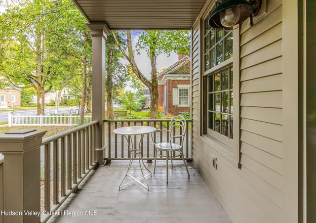 a dining room with a wooden table and chairs