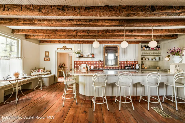 a dining hall with stainless steel appliances granite countertop a stove and cabinets