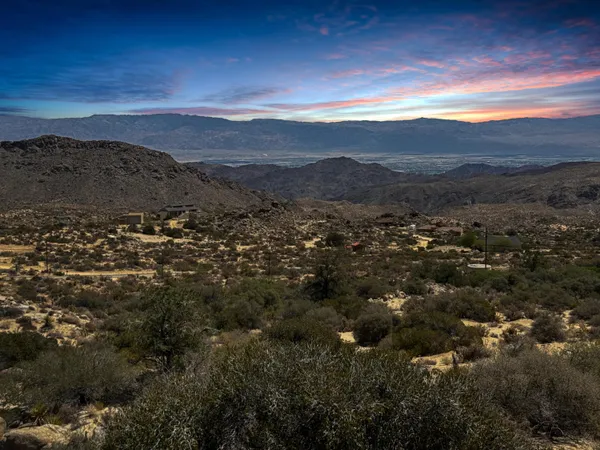 a view of mountain with sunset